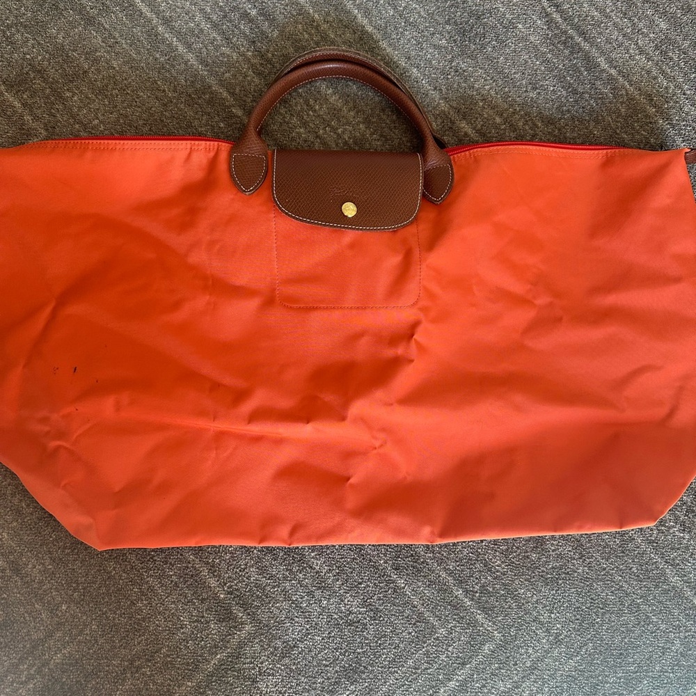Longchamp orange weekend bag .... gorgeous color, brown leather handles